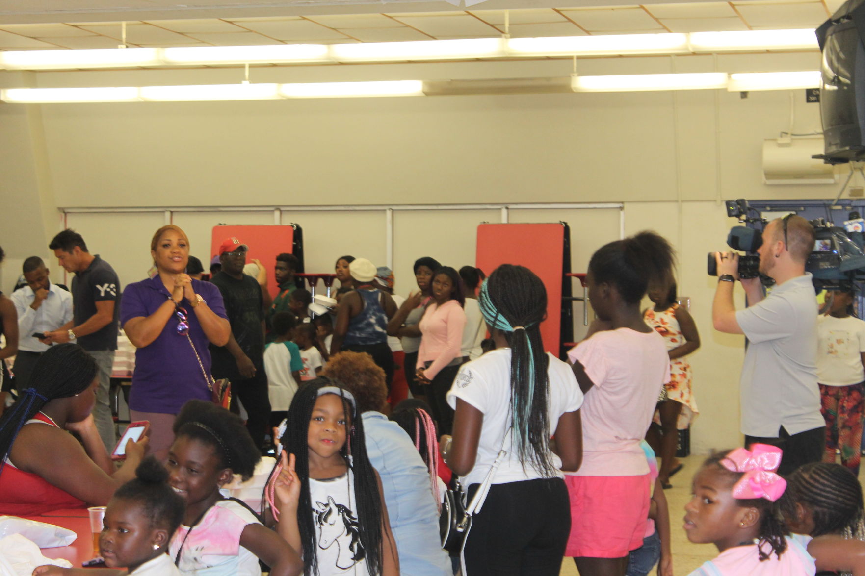 MCI CEO LaTousha Daniels organizes the students to receive their school supplies and uniforms.
